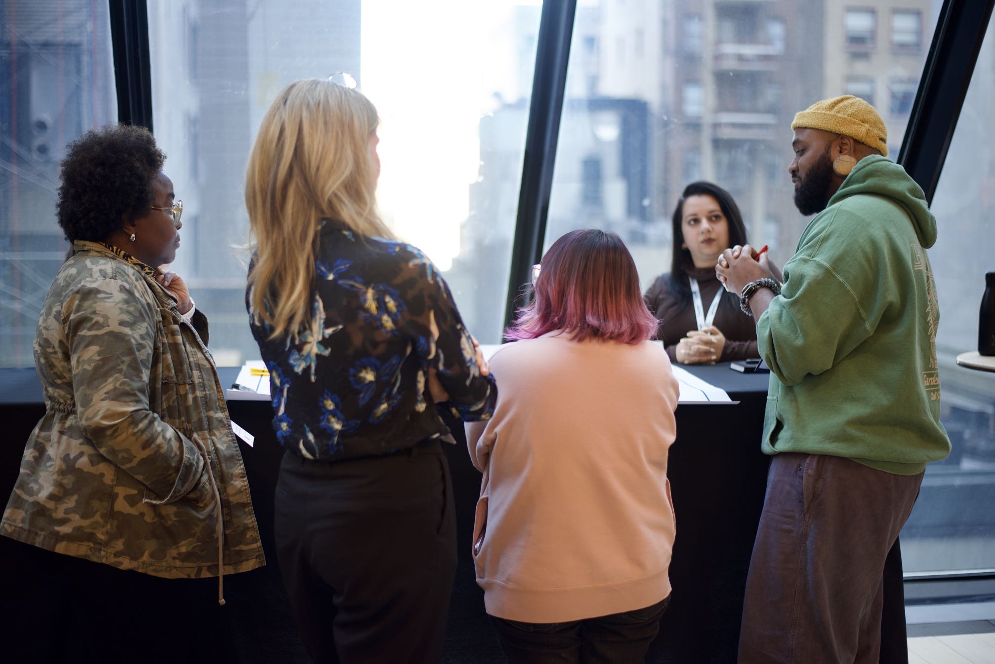 TB talks with 4 women design leaders, all stood up in front of huge windows looking out onto New York.