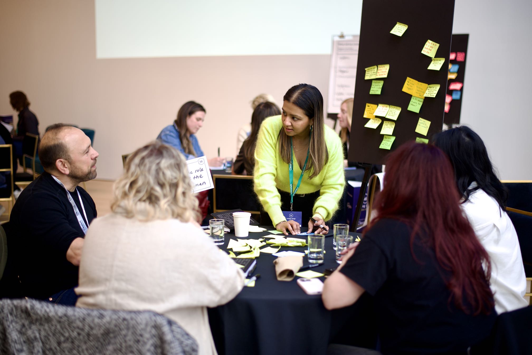A woman capture the thoughts of her table in Post-It form.